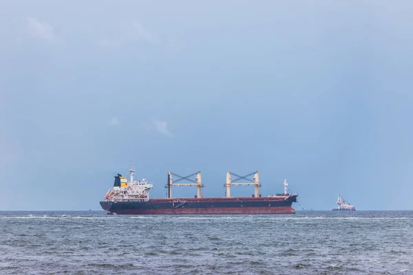 Cargo carrier container on the sea, in a cloudy day