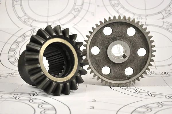 Set of gears on the background of drawings. Spare parts.