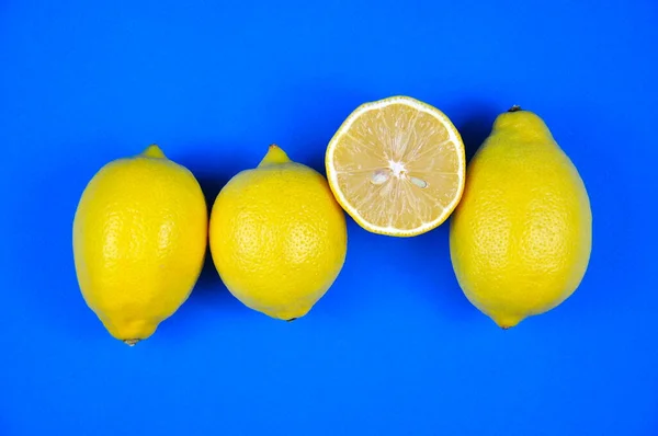 Ripe yellow lemons on a blue background. Banner.