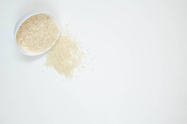 Beyaz arka planda izole edilmiş bir kase uzun tahıllı beyaz pirinç. Boşluğu kopyala.