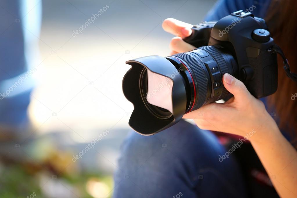 Holding a Full Frame Camera.