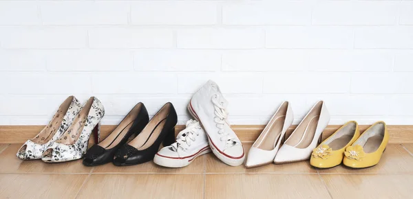 A row of women\'s shoes, high heel shoes and comfortable sneakers among them. the choice.