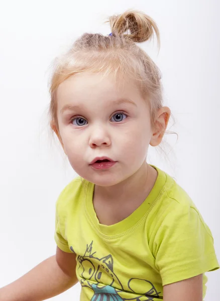 Surprised little girl looks in the picture — Stock Photo, Image