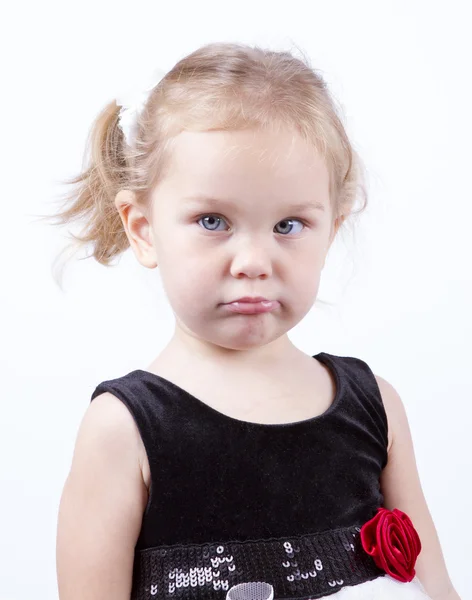 Little girl frowned pouted studio portrait. — Stock Photo, Image