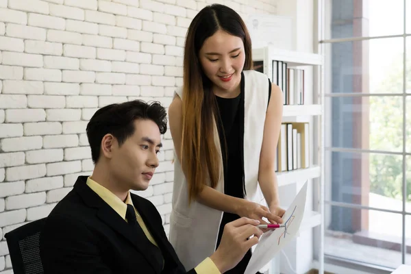 young asian manager discuss about income and profit of corporate with woman in office. business concept
