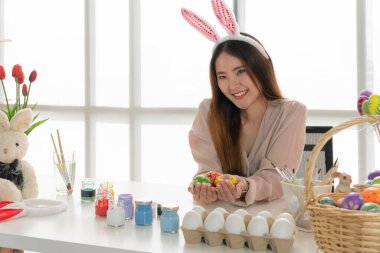 Paskalya yumurtalarını boyamak için boya kullanan güzel Asyalı kadın.