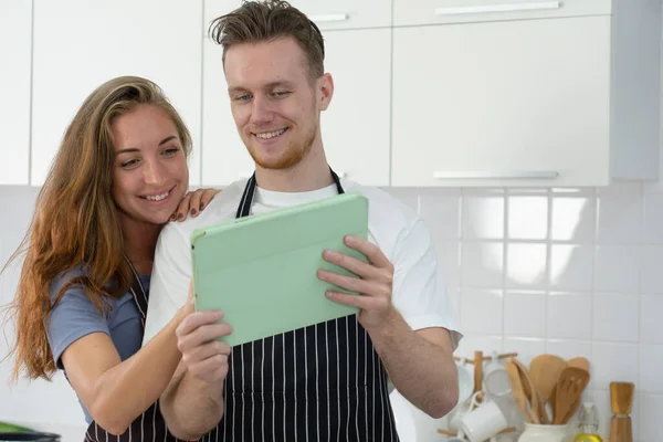 Young Caucasian Couple Reading Instruction New Cuisine Tablet Cooking Food — Stock Photo, Image