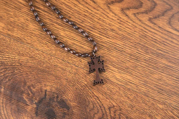 wooden cross on the wooden table