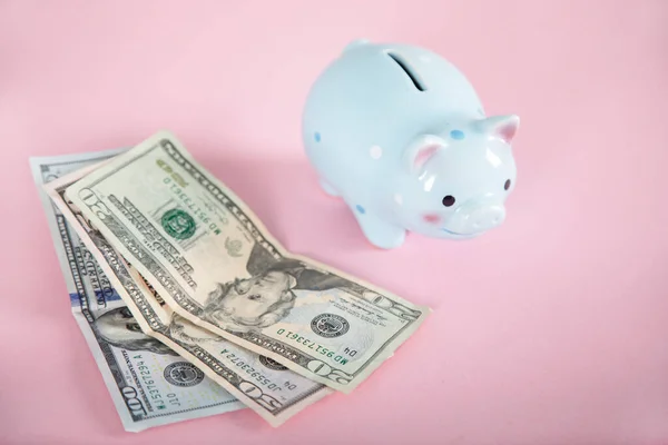 money with piggy bank on the pink background