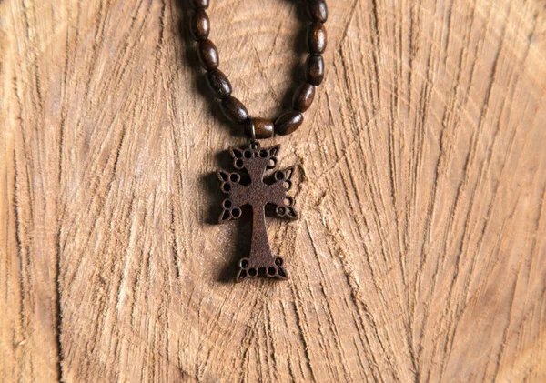 wooden cross on the wooden table background