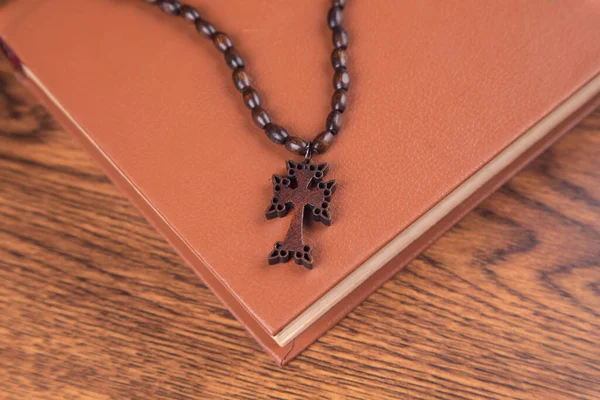 stock image cross with Bible on the wooden table