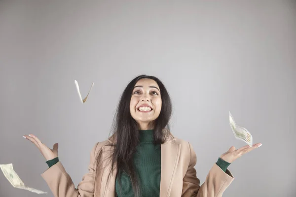 happy woman with money in the air