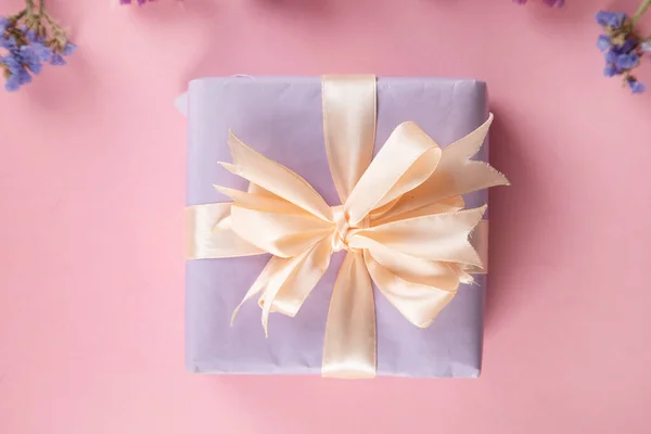 gift box with flowers on pink background