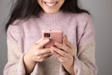 woman holding smart phone and touching screen