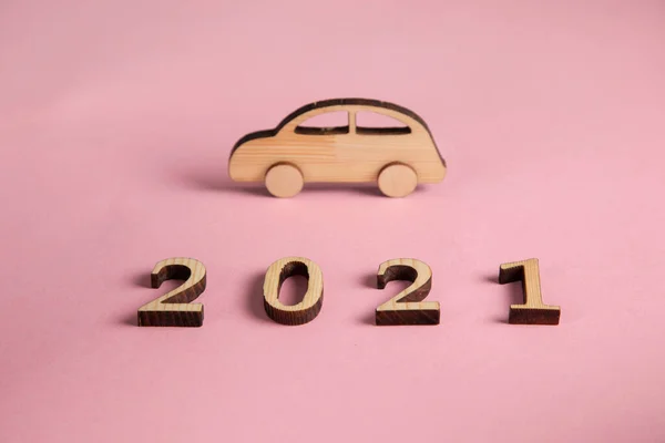 wooden car model with 2021 on table