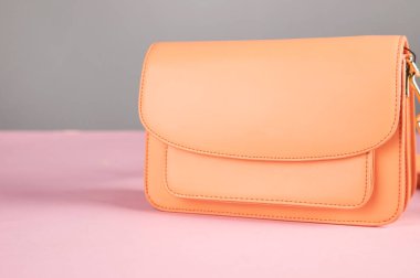 woman orange bag on the table background