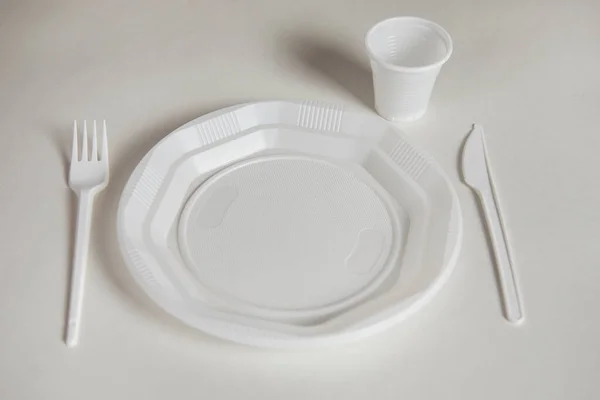 plastic plate with fork and knife and cup