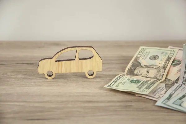 car insurance, wooden car model with money