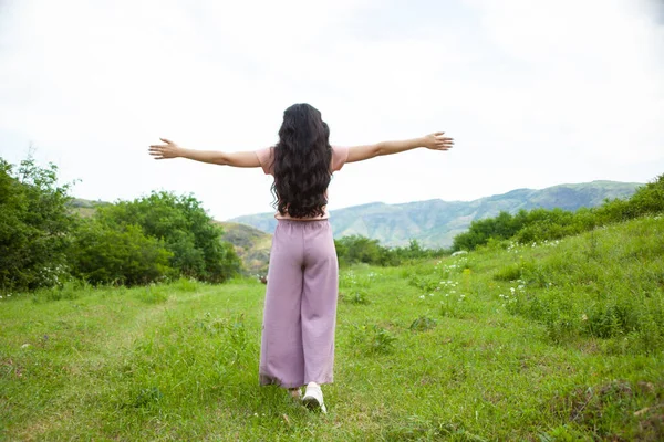 Young happy woman in nature background.