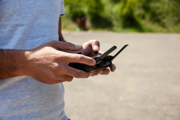 A man holds a drone control panel in his hands