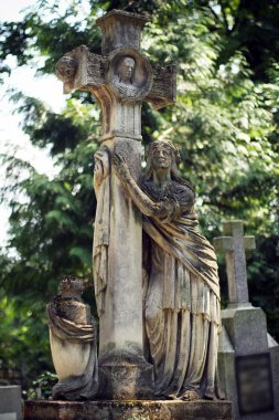 Old statue on grave in the Lychakivskyj cemetery of Lviv, Ukrain clipart