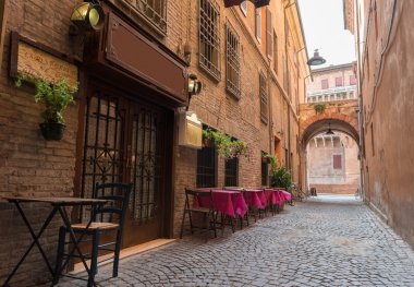 Old pub in a tiny alley in the city center of Ferrara Italy clipart