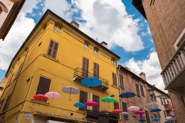 Ancient medieval street in the downtown of Ferrara city with umb — Stock Photo, Image