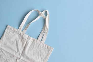 Bag made of cotton on a blue background. The concept of ecology.