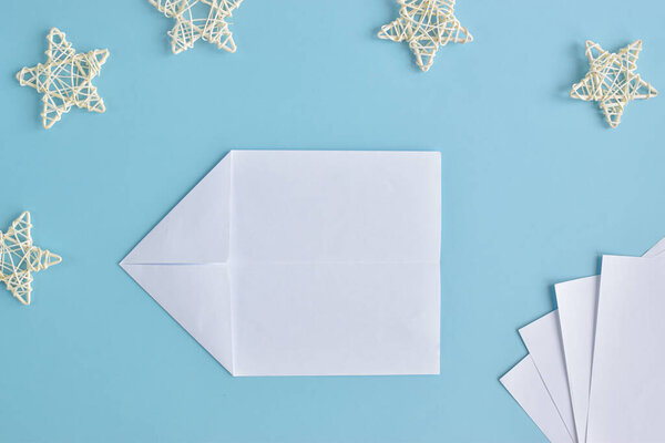 A homemade airplane made of paper. Step-by-step instructions. Top view. Step 3 Unfold the sheet and bend the corners.
