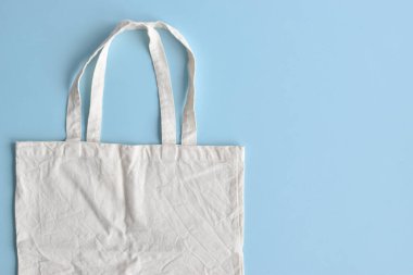 Bag made of cotton on a blue background. The concept of ecology.