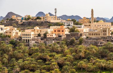 View of mountain village Misfat Al Abriyeen surrounded by the garden with date palms, Sultanate of Oman clipart