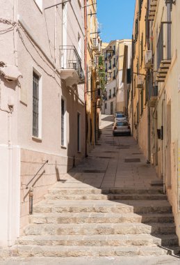 Cagliari, Sardinya, İtalya 'nın tarihi merkezinde dar bir kaldırım taşı caddesi. Geleneksel şehir mimarisi ve Akdeniz şehir atmosferi.