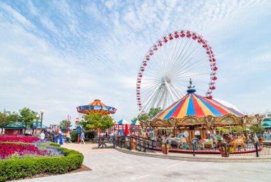 The Ferris Wheel and Carousel are popular attractions on Chicago's Navy Pier on Lake Michigan clipart