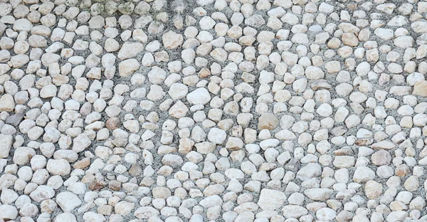 Background made a close seup of cobblestones pattern floor — стоковое фото