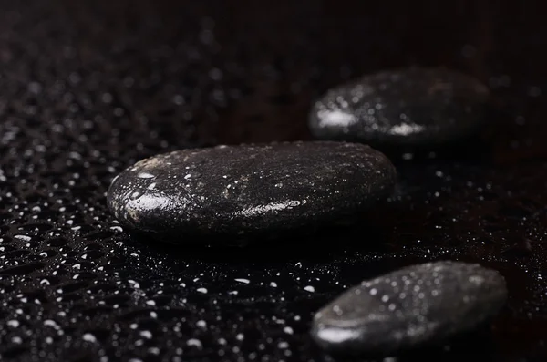 Black spa stones with water drops — Stock Photo, Image