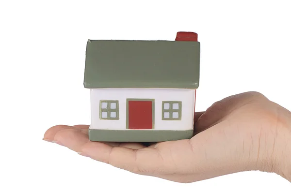 Модель іграшкового будинку в руці ізольовано на білому — стокове фото
