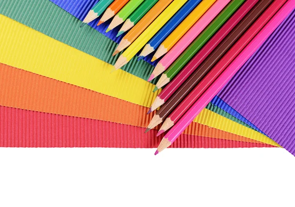 Color pencils on multi-colored paper — Stock Photo, Image