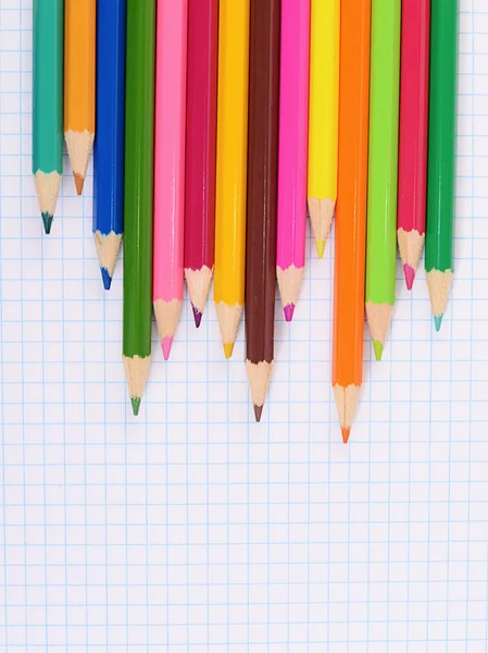 Color pencils against a sheet in cage — Stock Photo, Image