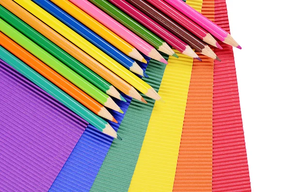 Color pencils on multi-colored paper — Stock Photo, Image