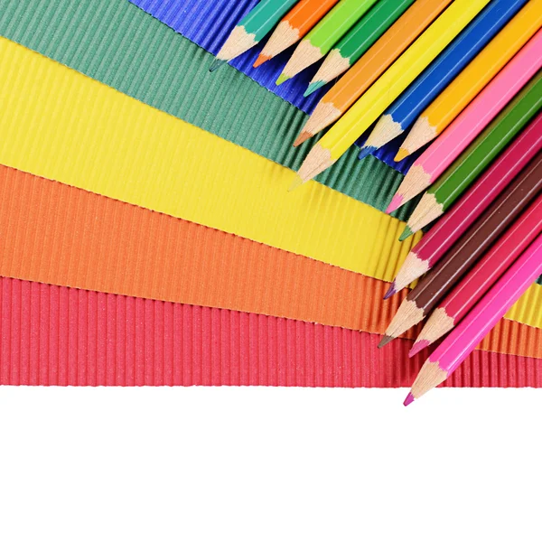 Color pencils on multi-colored paper — Stock Photo, Image