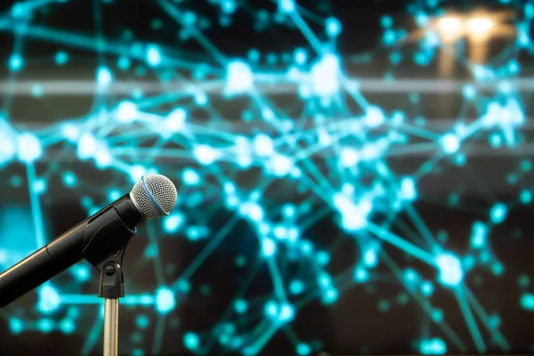 Public speaking backgrounds, Close-up the microphone on stand for speaker speech the seminar room with technology light background and blur bokeh.