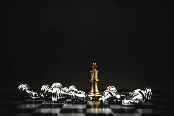 Close up king chess standing on chess board with falling chess concepts of business team and leadership strategy and organization management.