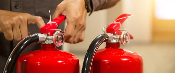 Firefighter Checking Safety Pin Handle Red Fire Extinguishers Tank Building — Stock Photo, Image