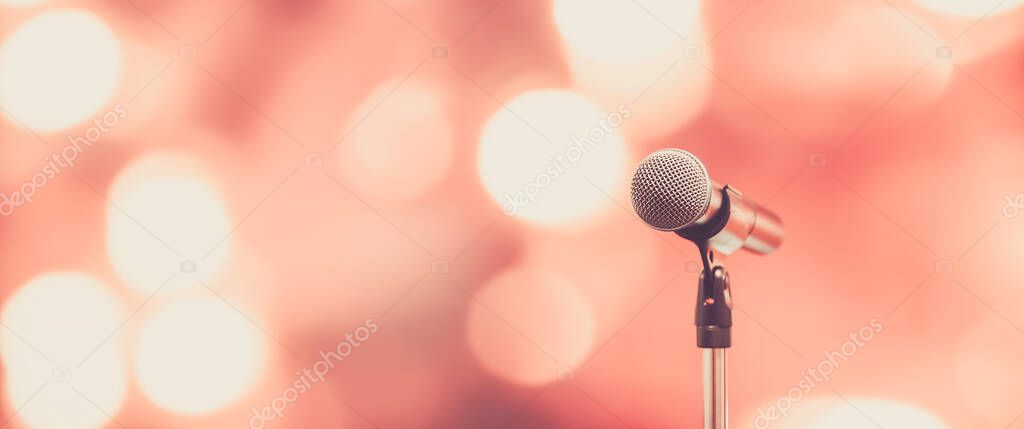 Public speaking backgrounds, Close-up the microphone on stand for speaker speech presentation stage performance with technology blur bokeh light background.