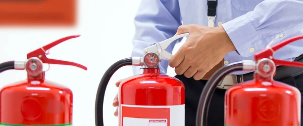 Firefighter Checking Handle Red Fire Extinguishers Tank Building Concepts Prevent — Stock Photo, Image