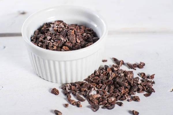 Bowl of raw cacao cocoa nibs — Stock Photo, Image