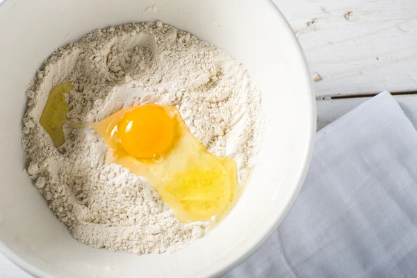 Flour and eggs in a bowl baking ingredients — Stock Photo, Image