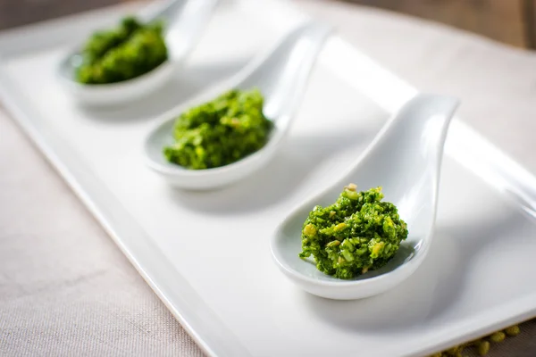 Kale Pesto sauce on white tasting spoon — Stock Photo, Image