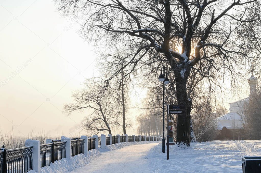 The embankment of Kirov in Russia on a sunny frosty winter day. Vyatka river. Scenic view. Pedestrian road.