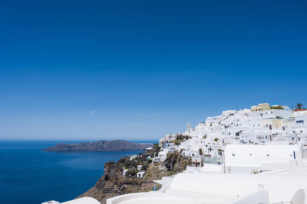 Scenic cityscape of Imerovigli. city on the hill. White architecture. Santorini island, Greece. Aegean sea. Luxury tourism.